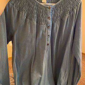 Blue top with a button and ruffle details